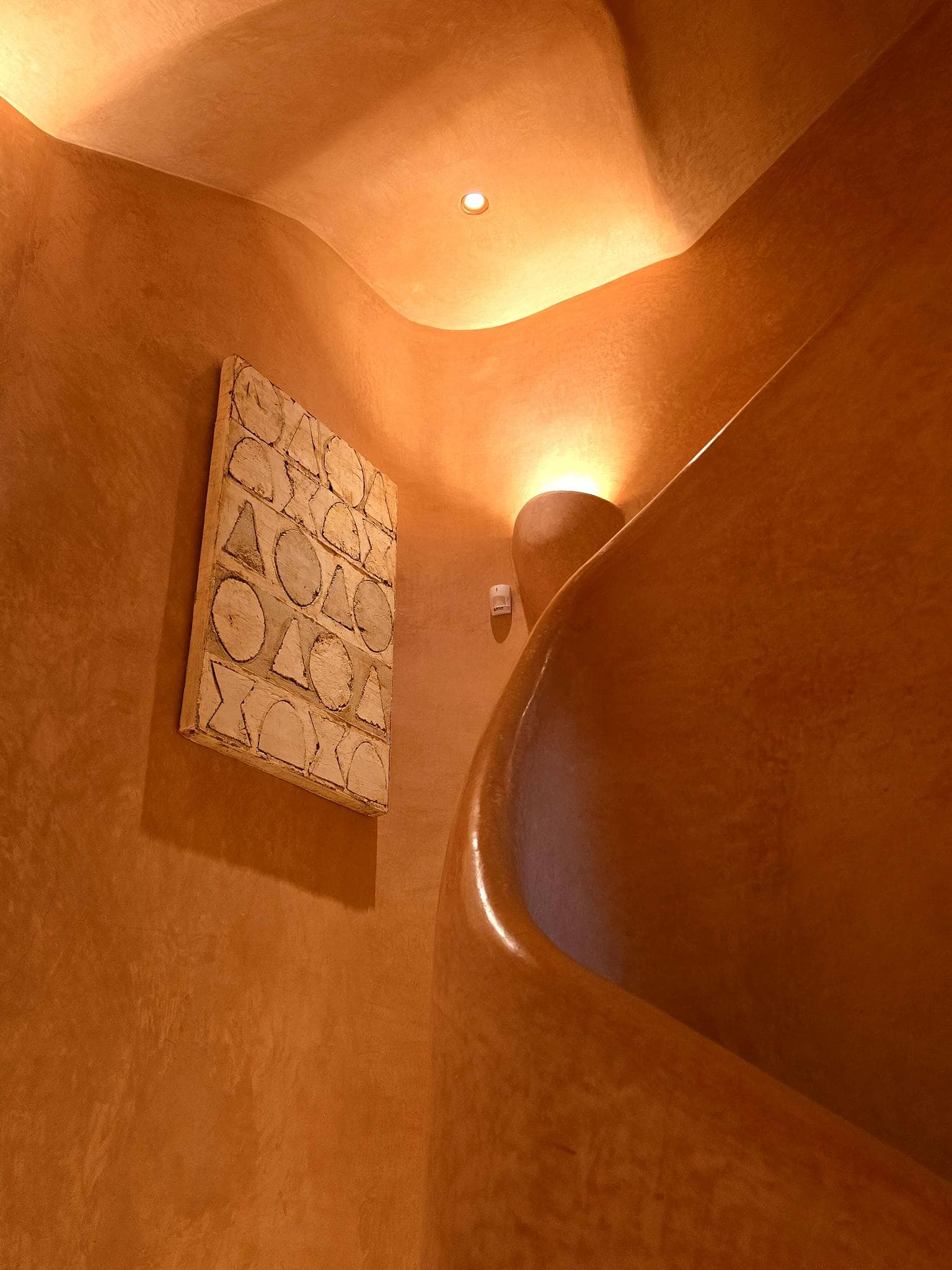 Curved stairwell with geometric wall art